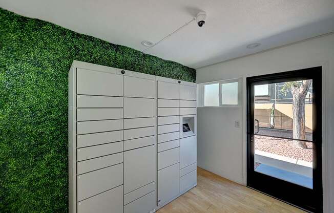 A room with a green wall and a white cabinet.