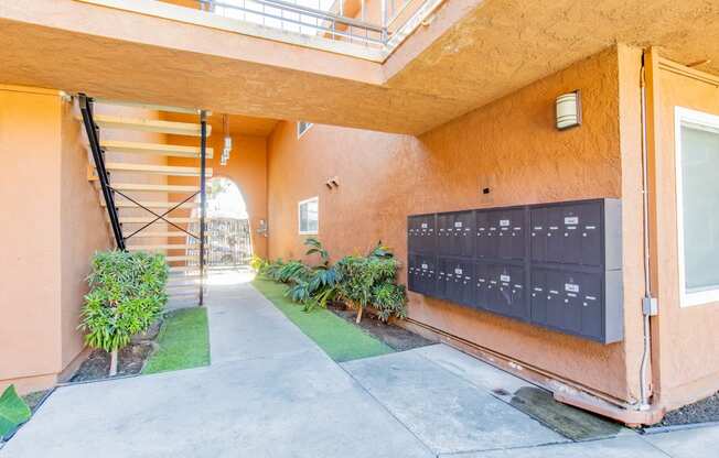 the entrance to a building with a mailbox and a staircase