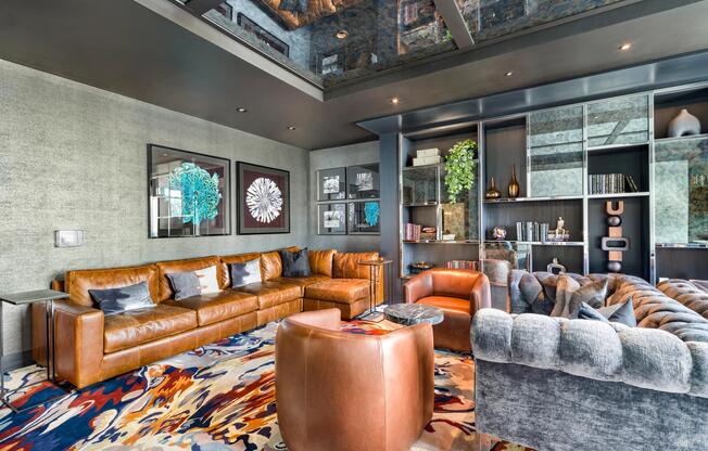 Resident club room with rich textures, custom millwork, and skyline-facing seating areas designed for intimate gatherings and elevated city views.
