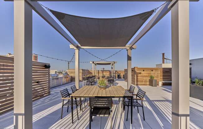 Rooftop terrace at The Mint Rahway with dining and lounging areas, offering stunning views, close to Rahway Train Station and Union County Performing Arts Center.