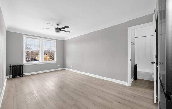 A room with a ceiling fan and a window with a view at Pleasant Oak Apartments, Oak Park, 60302