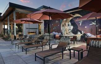 A mural of a woman is on the side of a building.