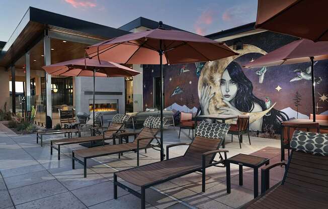 A mural of a woman is on the side of a building.