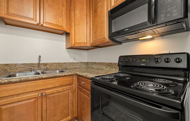 Apartments For Rent In West Hills, CA - Topanga Canyon - Kitchen With Upgraded Cabinets & Countertops And Black Appliances