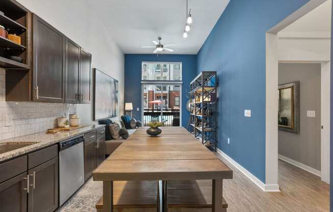 an open kitchen and dining room with a large wooden table