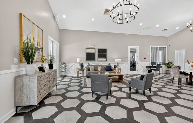 A spacious living room with a grey and white patterned floor.