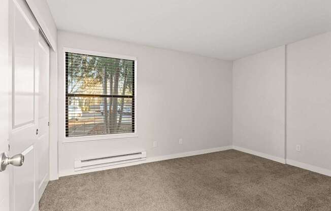 A room with a window and a door.