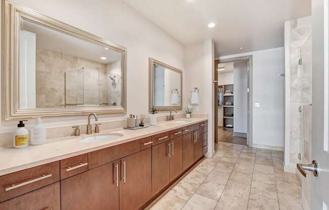 a large bathroom with two sinks and a large mirror
