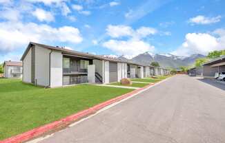 a row of rental houses with mountains in the background