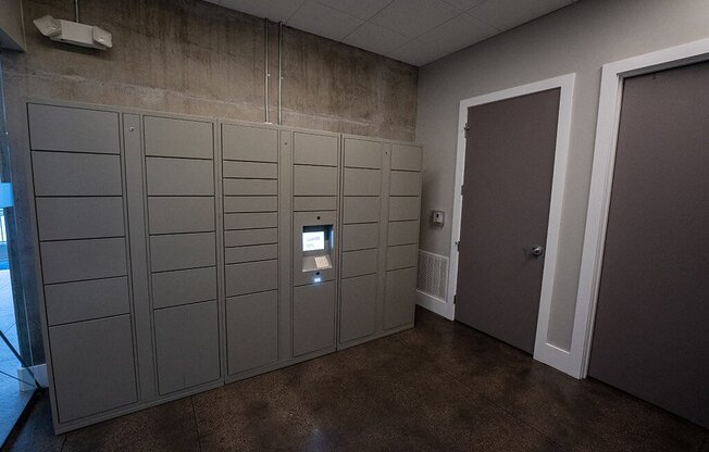 a room with several lockers and a door to a hallway