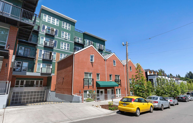 a view from the street of a brick building with a green awning at Sedona Apartments, Seattle