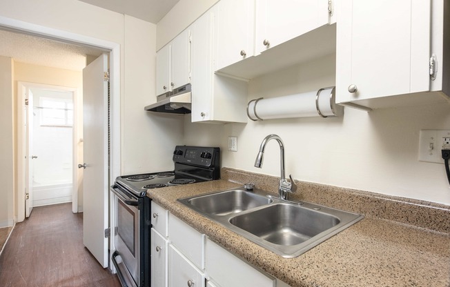 a kitchen with a sink and a stove and a window