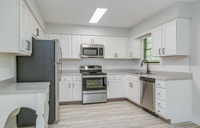 Full stainless-steel appliance package in townhome platinum kitchen at The Abor in Blue Springs, MO