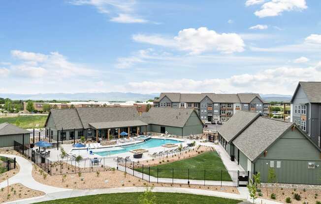 an aerial view of an apartment complex with a swimming pool