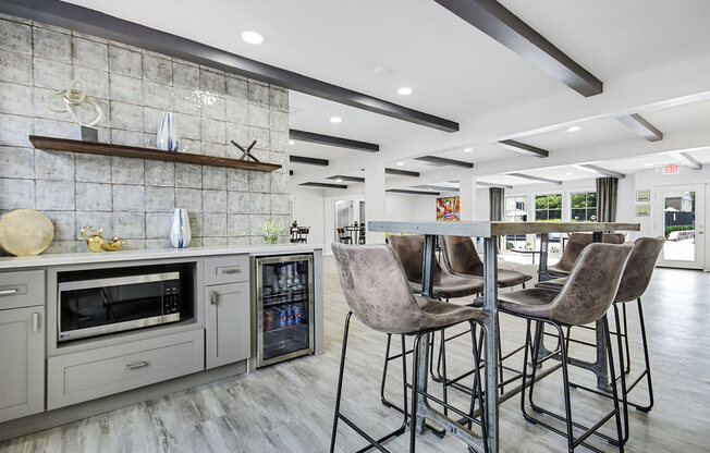 a kitchen with bar stools in front of a counter top