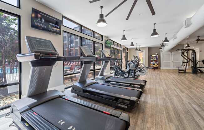 a gym with treadmills and other exercise equipment