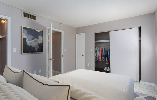 a bedroom with a large bed and a closet