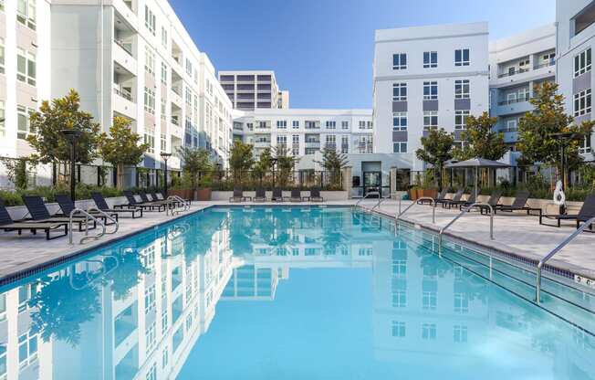 a swimming pool with a building in the background