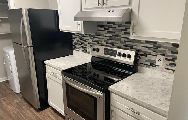 a stove top oven sitting inside of a kitchen