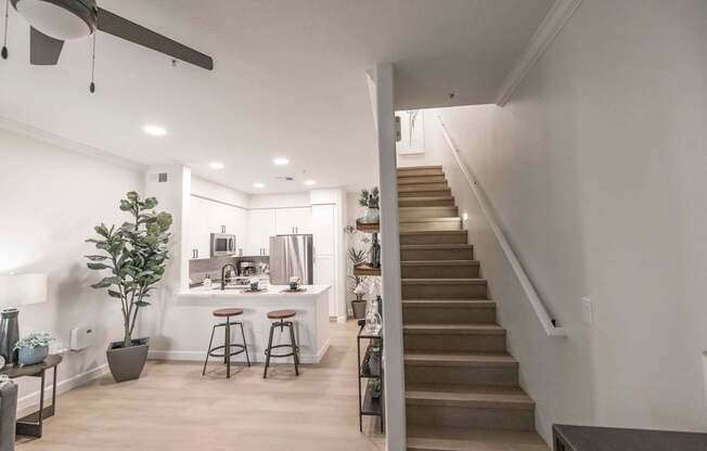 A living room with a staircase leading to the upper floor.