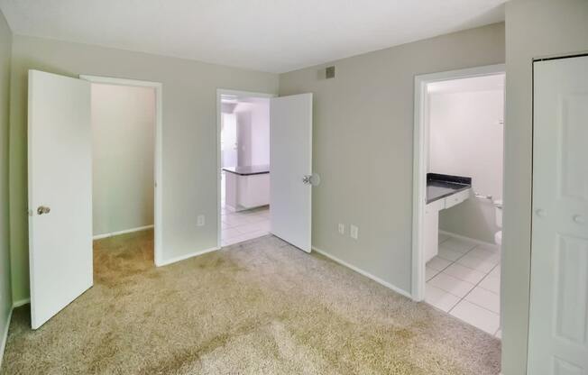 an empty room with a bathroom and a closet