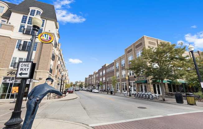 a statue of a man on the corner of a city street