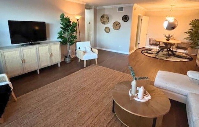 A living room with a brown carpet and a white sofa.