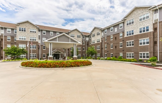 an empty parking lot in front of an apartment building