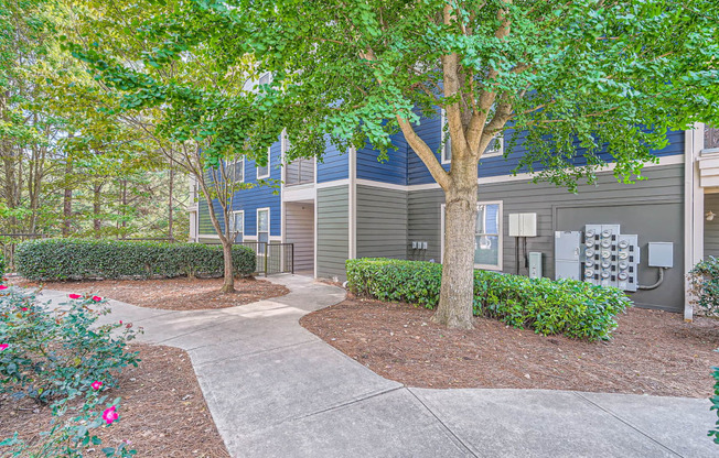 a walkway in front of a building with trees