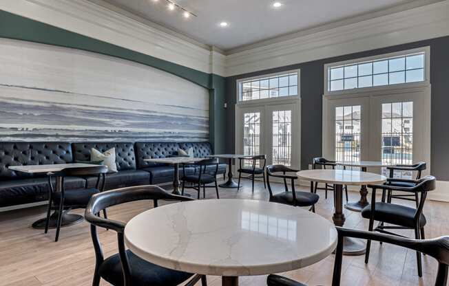 a dining room lounge with tables and chairs and a wall mural