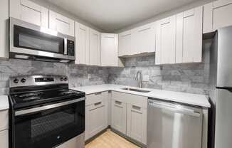 Kitchen with stainless steel appliances and shaker-style cabinets