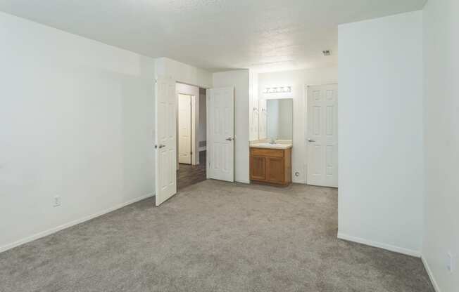 an empty living room with white walls and a bathroom