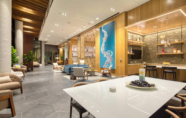 a lobby of a hotel with a table and chairs