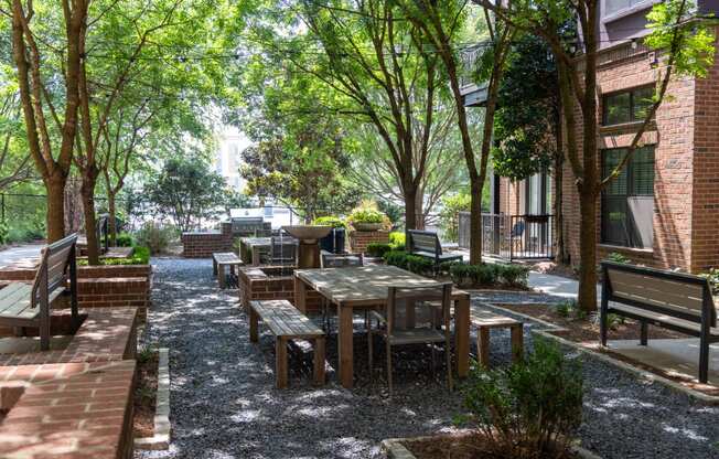 a courtyard with wooden tables and benches