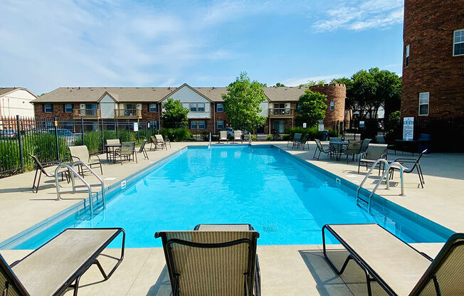 lounge chairs by pool at Abbey Court Apartments