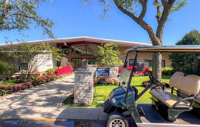 A golf cart is parked in front of a house with a sign that says "Welcome to Paradise.".