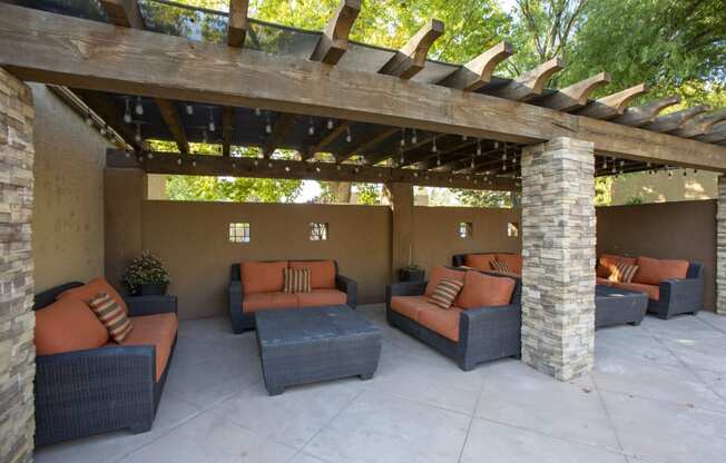 a patio with couches and a pergola