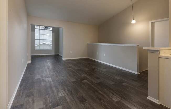 a view of an empty living room from the top of a staircase