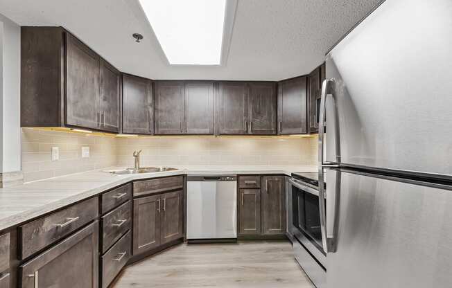 a kitchen with dark wood cabinets and white appliances