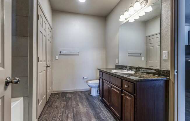 a bathroom with a toilet sink and mirror