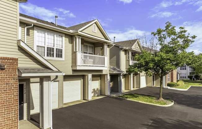a row of town homes with garages and trees