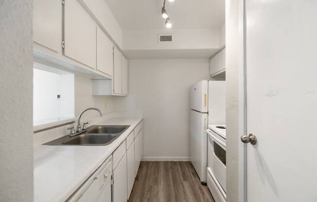 the preserve at ballantyne commons apartment kitchen with sink and white cabinets