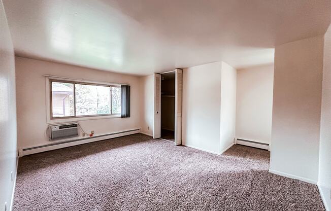 A room with a window and a door.