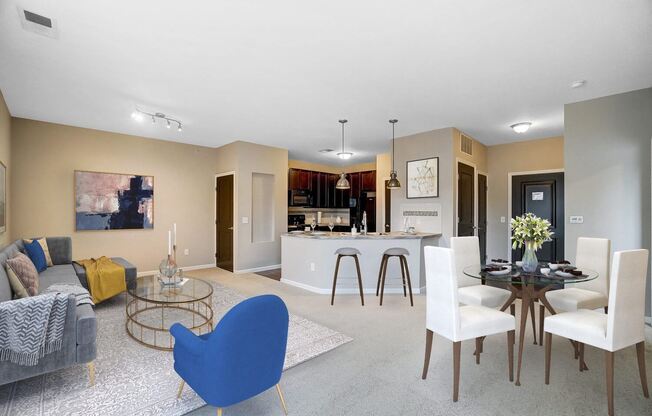 a living room and kitchen with a table and chairs