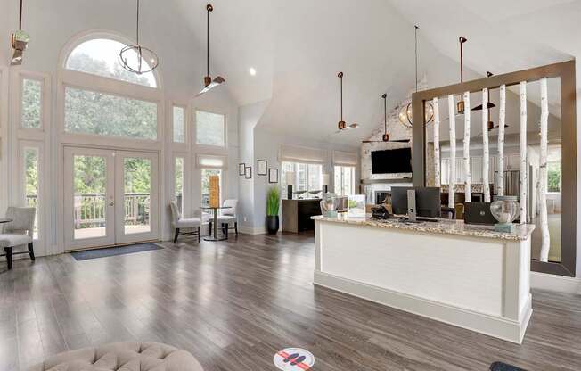 a large living room with a bar and a kitchen