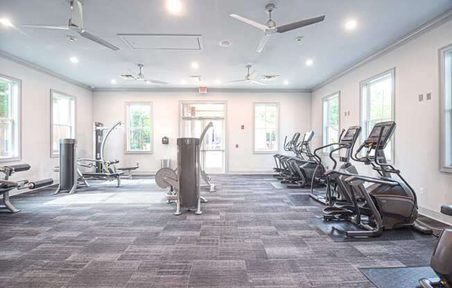 a fitness room with cardio equipment and exercise machines