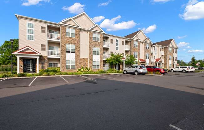 an empty parking lot in front of an apartment building