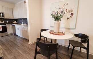 a kitchen with a table and chairs and a painting on the wall at The Crest at Acworth, Acworth