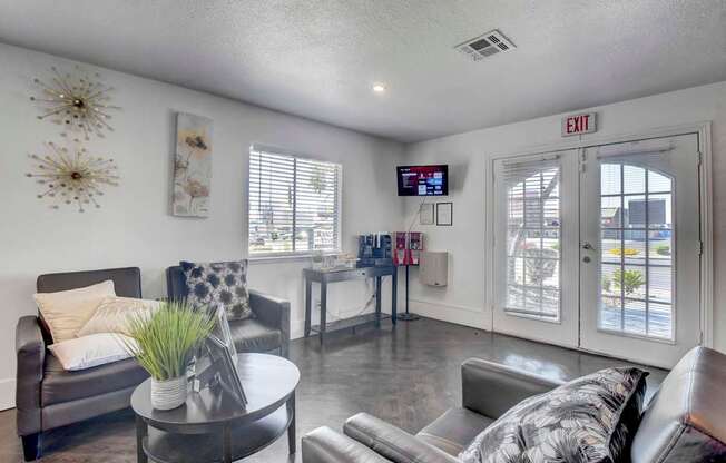 A living room with a grey couch, a coffee table, and a TV screen.