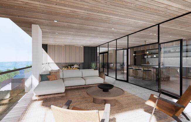 Oceanfront terrace featuring comfortable seating, cozy fireplace, and seamless indoor-outdoor flow.